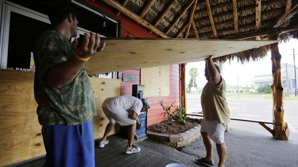 Business owners in Port Aransas, Texas, board up in expectation of Hurricane Harvey.