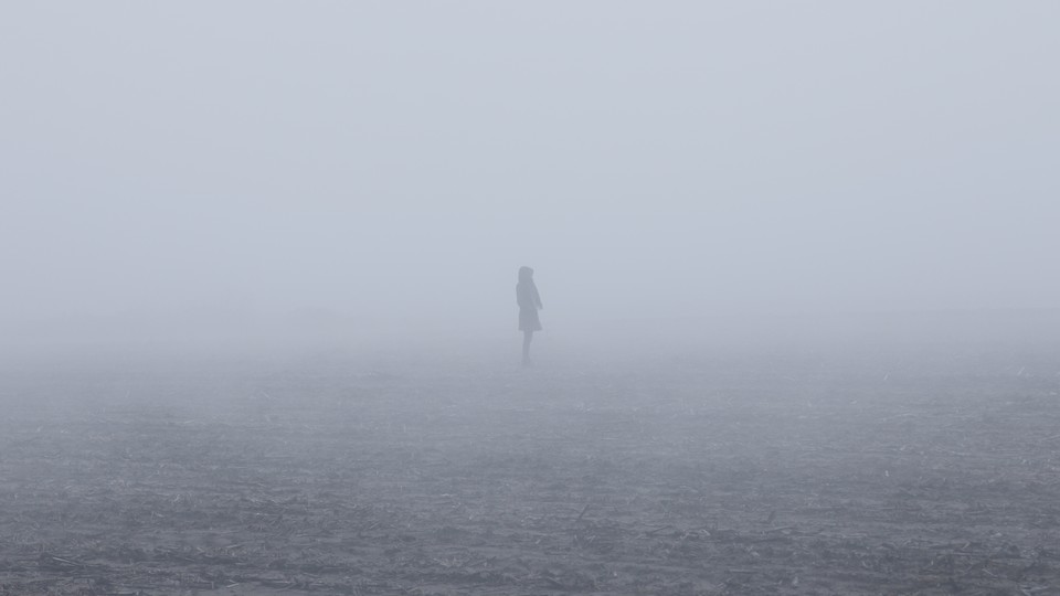 A woman walking in the mist