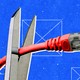 Illustration of a pair of scissors trying to cut through a red ethernet cable