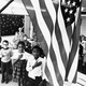 A teacher and her schoolchildren pledging allegiance to the American flag