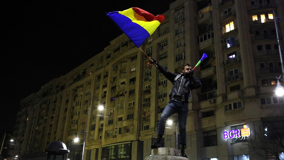 A protester waves Romanian flag during a demonstration in Bucharest, Romania.