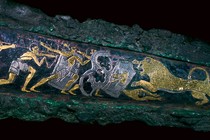 A Mycenaean bronze dagger showing a lion hunt