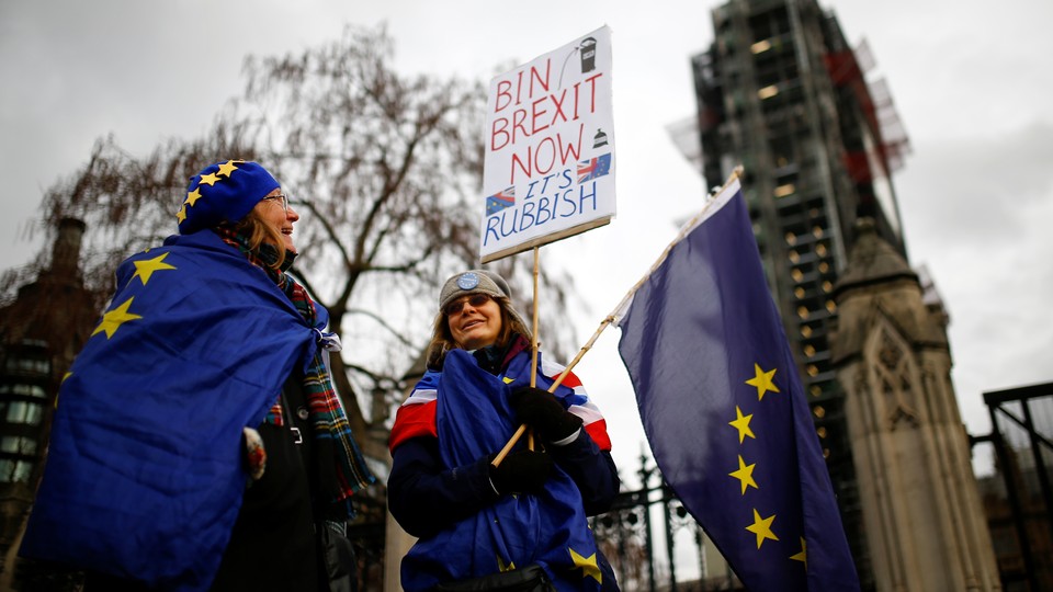 Anti-Brexit protesters are seen outside the Houses of Parliament in London on January 29, 2019.
