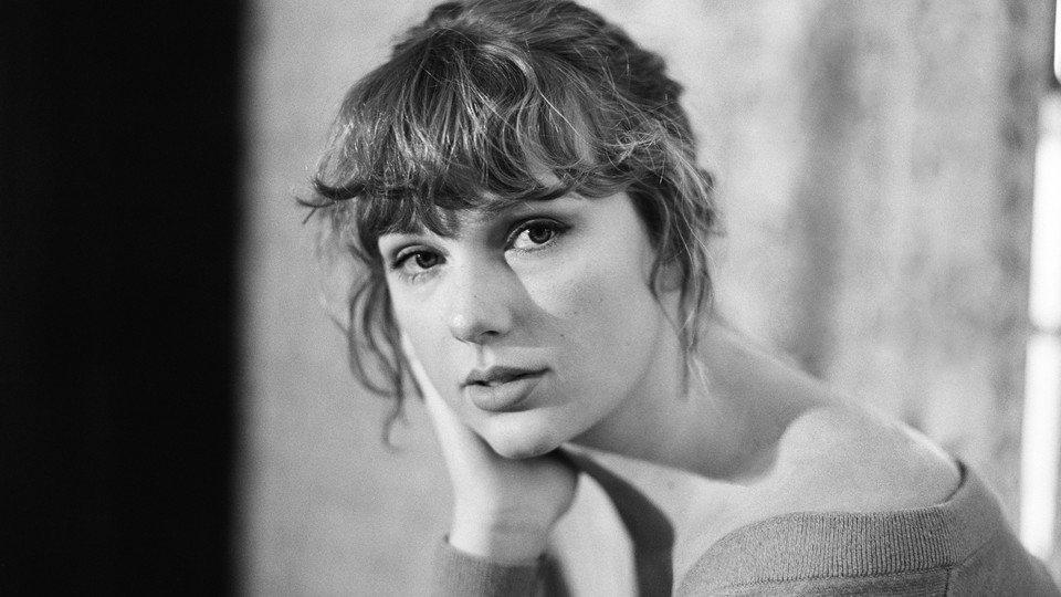 A black-and-white photo of Taylor Swift looking directly into the camera