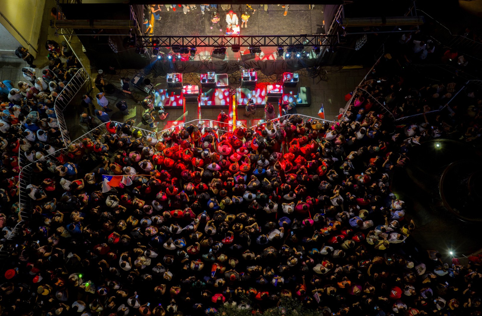 An aerial view of a crowd gathered in front of a stage to see a presidential candidate in Chile.