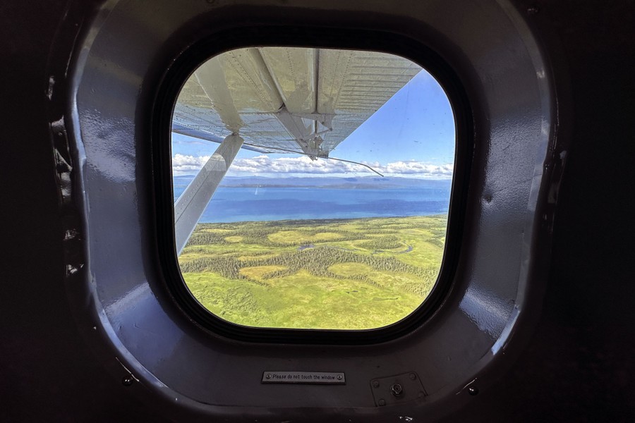 A view of an Alaskan lake from inside a small plane.