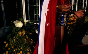 A waist-down view of a reveler wearing a red, white, and blue flag
