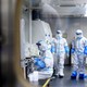 People in hazmat suits working in a COVID-detection lab