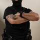 Photograph of two masked ICE officers from the neck down