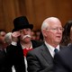 A monocle-wearing spectator looks on as Richard Smith, the former chairman and CEO of Equifax, testifies before the U.S. Senate Banking Committee.