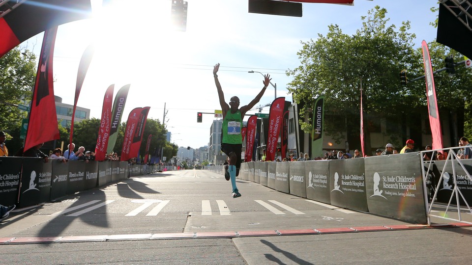 A runner excitedly crossing a finish line