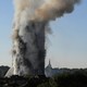 Smoke billows as firefighters deal with a serious fire in a tower block at Latimer Road in West London on June 14, 2017. 