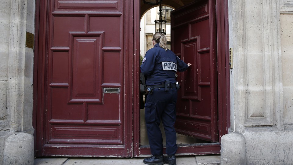 A police officer enters the residence on the Rue Tronchet in Paris, France, where Kim Kardashian West was robbed. 
