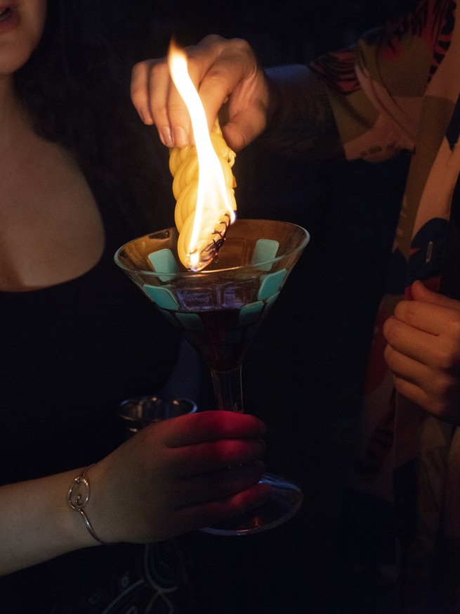 putting out a candle in a wine glass