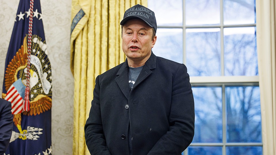 Elon Musk looks down while speaking from the Oval Office