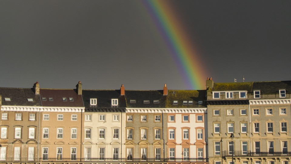 Photograph of a rainbow over houses in the UK