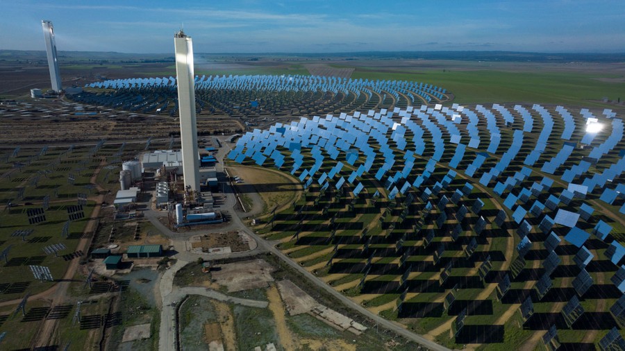 An aerial view of a solar-power tower and array of mirrors