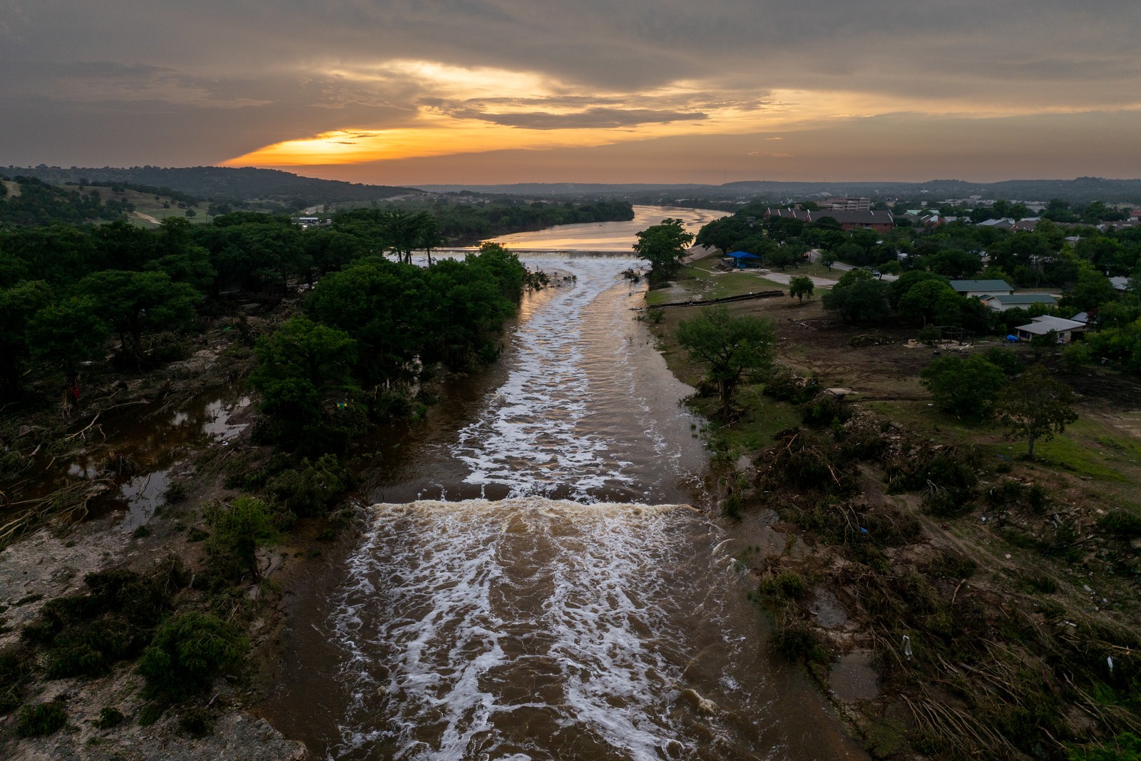 An aerial view of the sun setting over the Guadalupe River