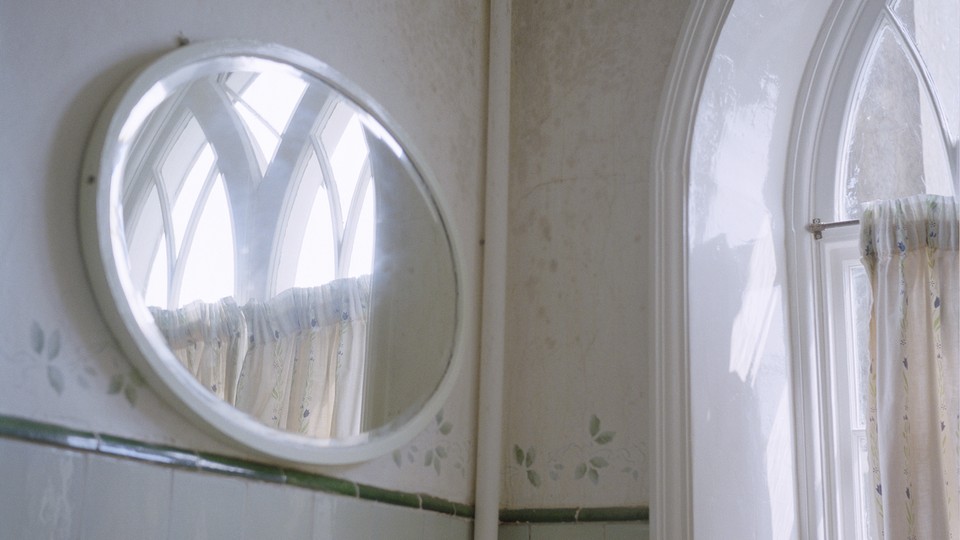 A photograph of a mirror in a bathroom