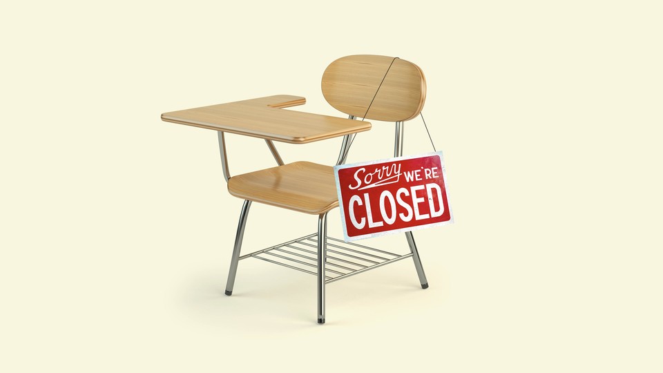 School desk with a sign that says "Sorry we're closed" hanging from the chair.