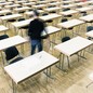 A man walks out of an empty classroom