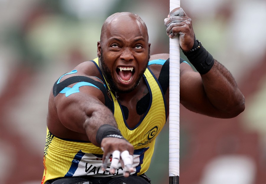 A paralympic athlete throws a shot put.