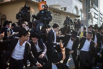 Mounted members of the Israeli security forces try to disperse ultra-Orthodox Jewish protesters as they block a road during a demonstration against army recruitment, in Bnei Brak, Israel, August 6, 2018.