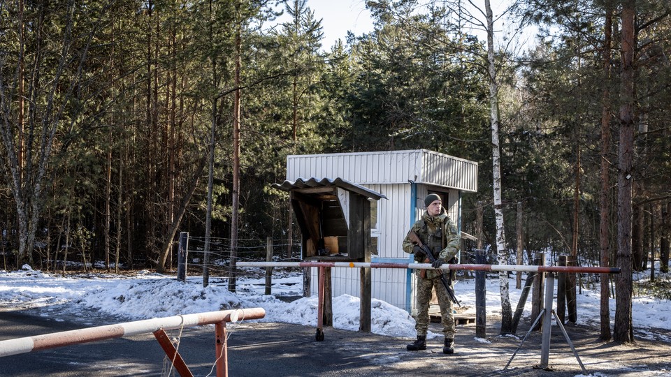 A Ukrainian soldier patrolling at a border crossing.