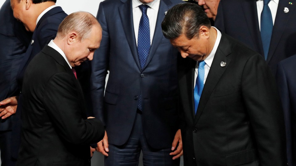 The Russian and Chinese president greet each other at the G20 summit.