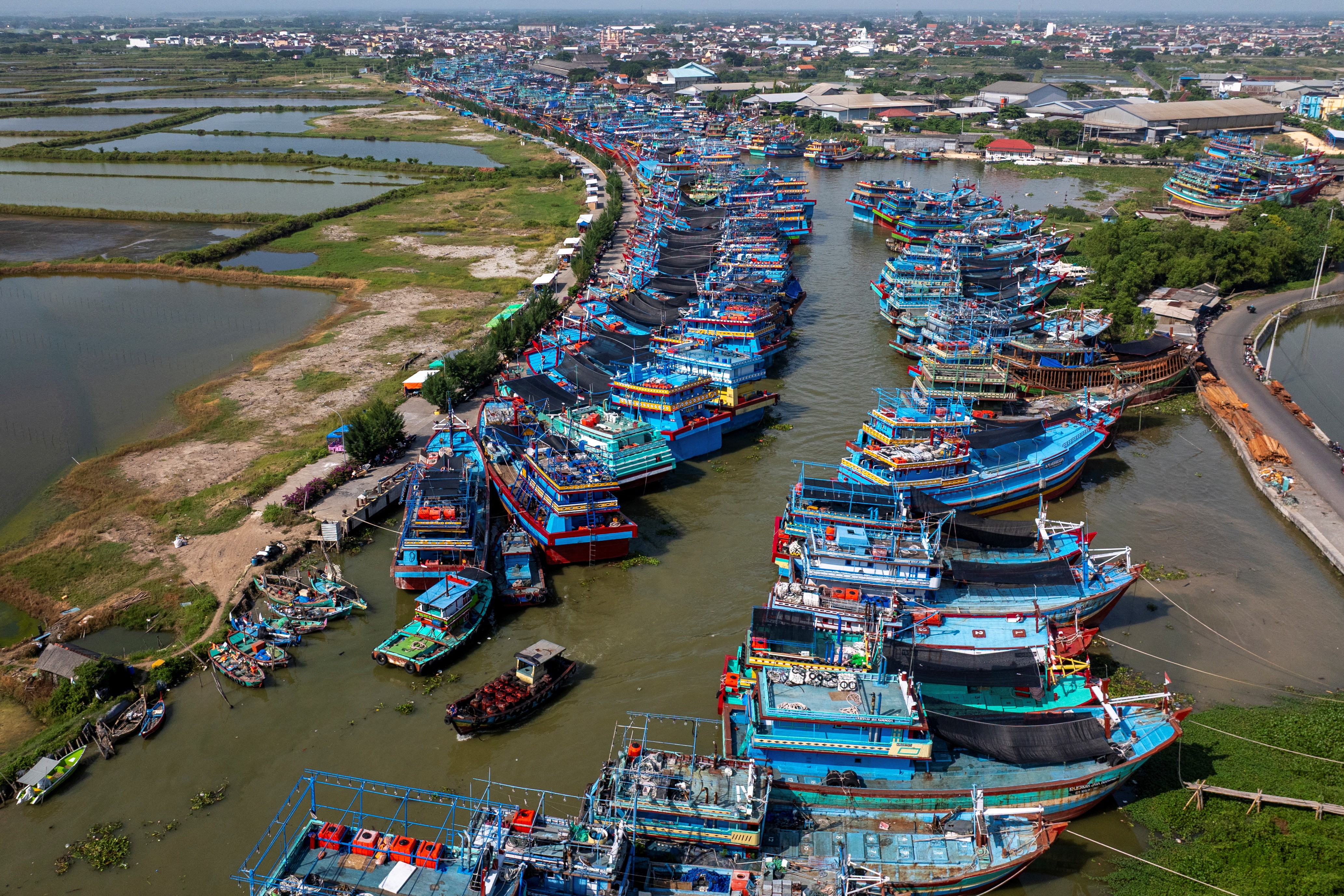 An aerial view of many docked fishing boats