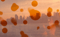 A fuzzy photo of the skyline of NYC with orange circles overlaying