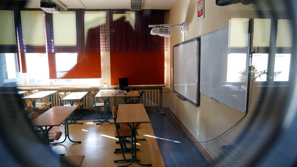 Empty classroom seen through a peephole.
