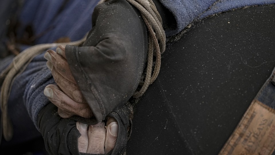 A close-up of a person's hands tied with rope