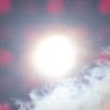 An photo of wispy clouds with a blurry sun, and pink dots across the image