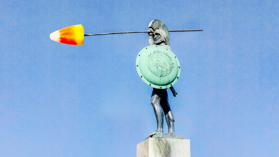 An ancient statue of a warrior, with a piece of candy corn as his spear tip