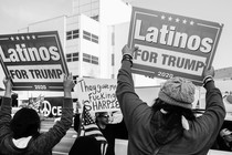 Two Trump supporters hold placards saying "Latinos for Trump" during a rally in Los Angeles.