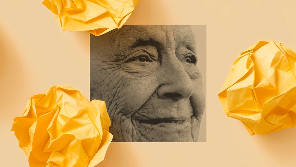 A black-and-white photo of an elderly person with a wrinkled face smiling and looking into the distance