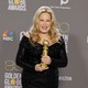 Jennifer Coolidge poses with the award for Best Supporting Actress in television at the Golden Globes.