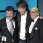 Jann Wenner, left, accepts his Rock and Roll Hall of Fame induction award from Mick Jagger and Atlantic Records founder Ahmet Ertegun 2004.