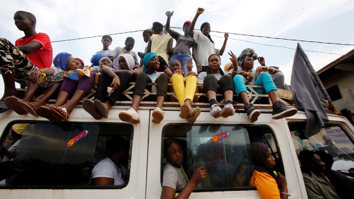 Supporters of the United Democratic Party opposition alliance presidential candidate Adama Barrow attend a campaign rally on November 29, 2016.
