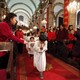Chinese children walk down the aisle during Christmas Mass at a Catholic church in Beijing.