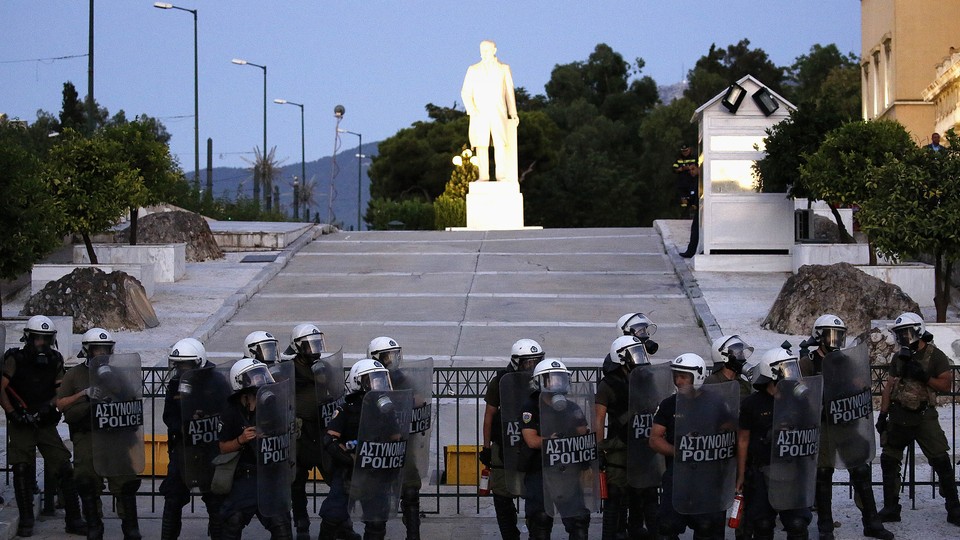 Riot police stand guard outside the Greek Parliament in 2015.