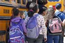 Students board a bus. 