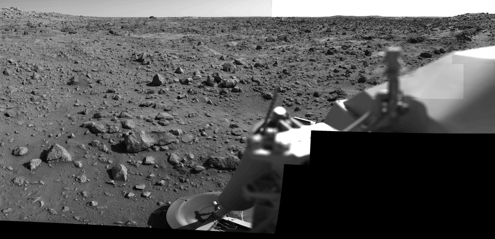 A panoramic view of the surface of Mars, with part of Mars Lander spacecraft seen in the foreground.