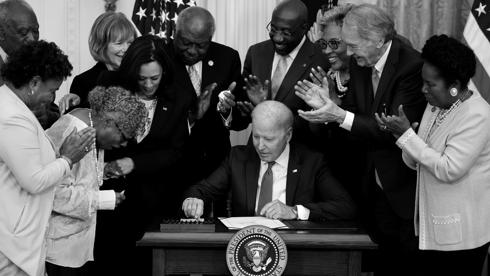 Joe Biden signs Juneteenth bill.