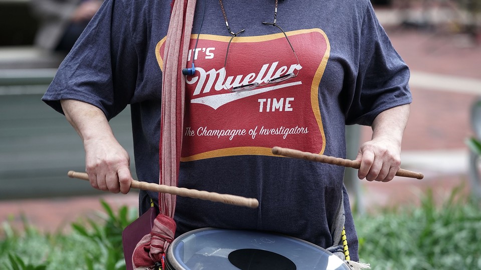 A man beats a drum in a Mueller T-shirt