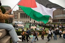 A photo of pro-Palestine protesters marching with signs on Columbia University's campus