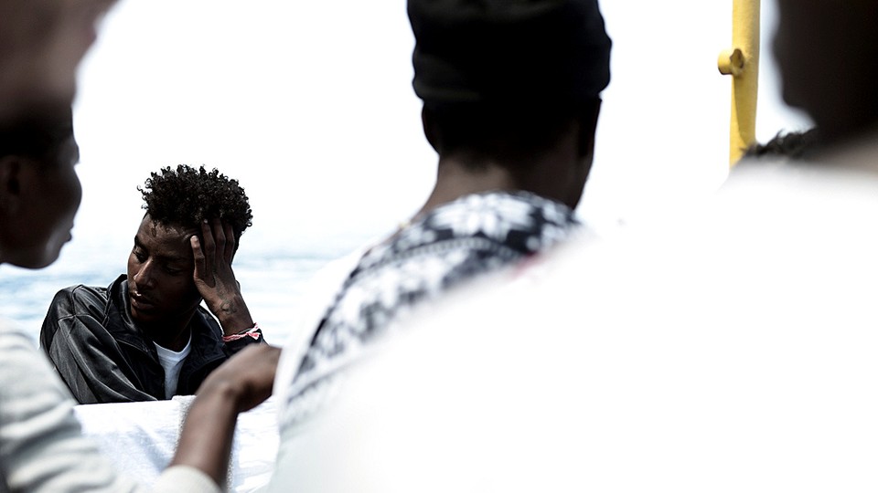 Migrants are pictured on the deck of the MV Aquarius in the central Mediterranean Sea on June 12, 2018. 