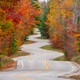Fall colors cover trees along a curvy road in Wisconsin.