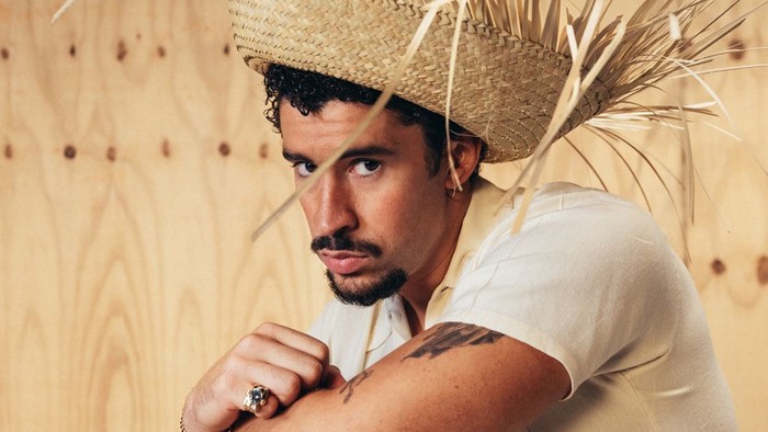 A photo of Bad Bunny wearing a straw hat